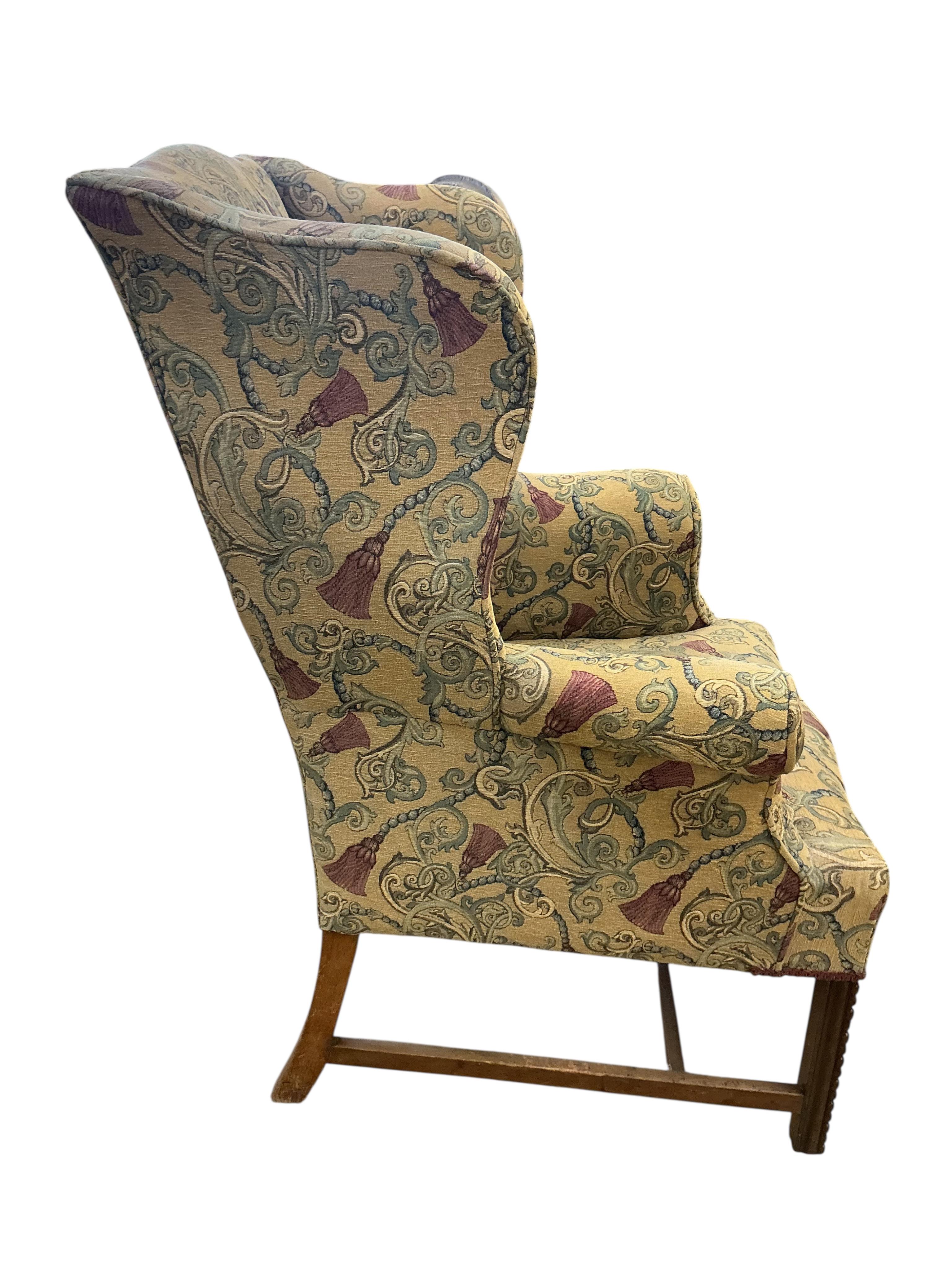 A George III style upholstered wing armchair, width 78cm, depth 66cm, height 103cm